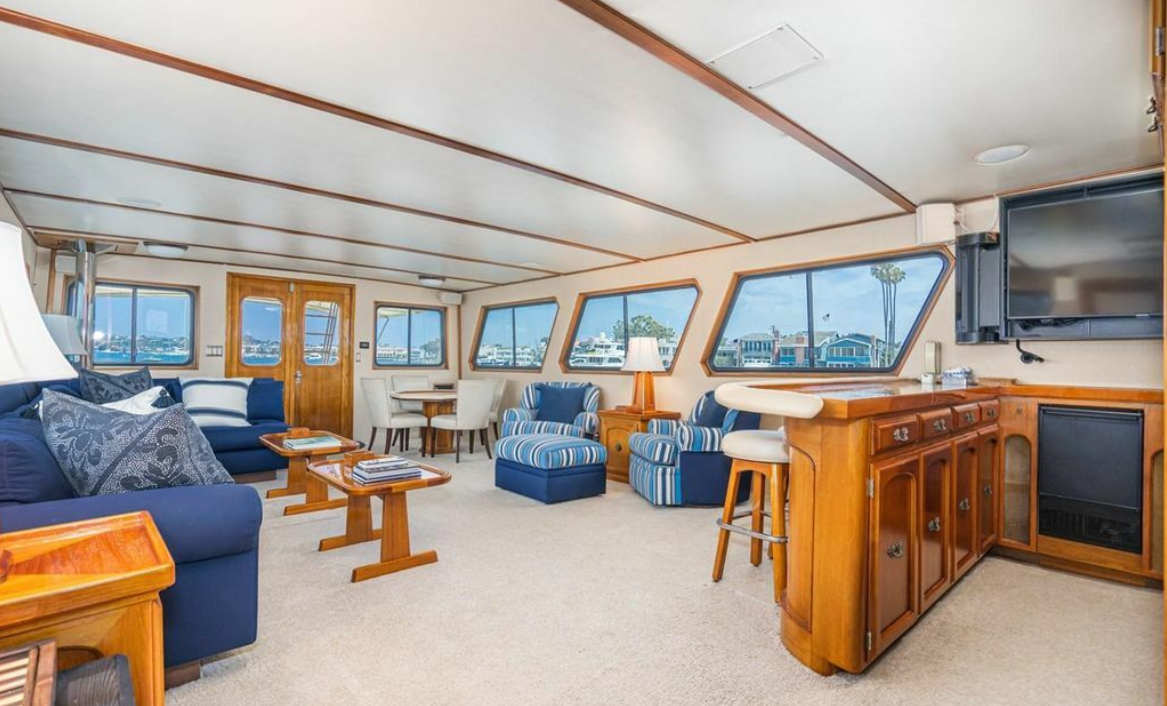 Main salon lounge with blue seating and bar aboard M/Y Oceana