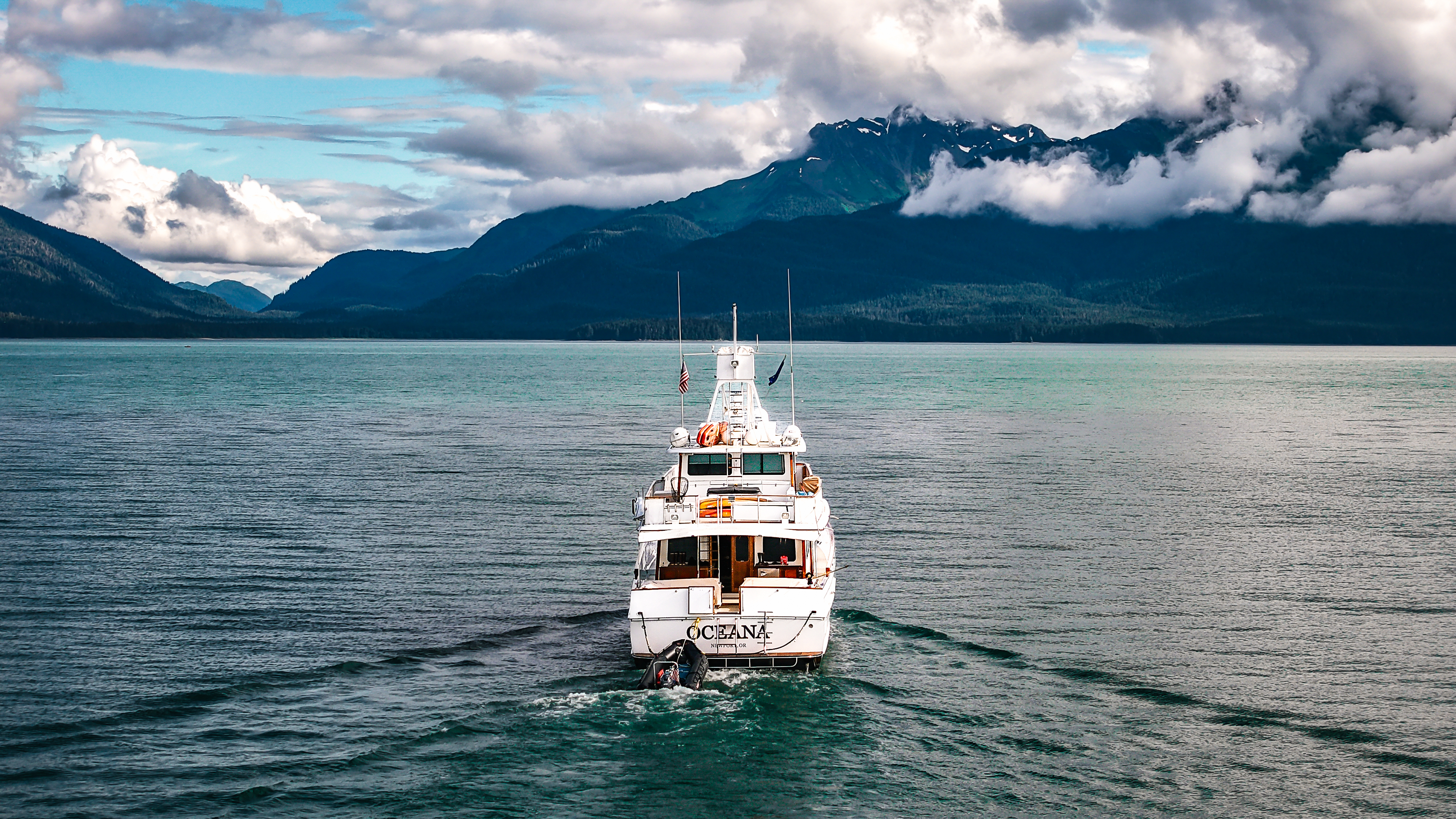 Motor Yacht Oceana underway in Southeast Alaska, mountains and turquoise water